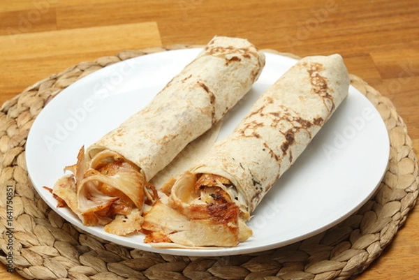 Fototapeta Chicken Doner wrapped in thin lavash and seasonal salad