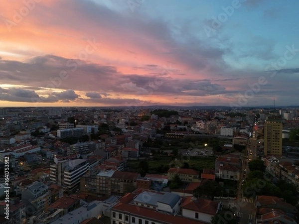 Fototapeta 4K Aerial Sunset Drone Footage Over Urban Rooftops, Riverfront from Above with Golden Hour Lighting