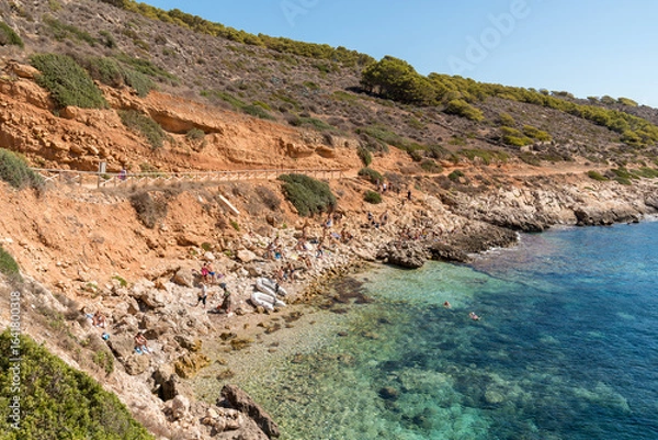 Fototapeta Levanzo, Trapani, Italy - September 22, 2016: Tourists relaxing on Cala Fredda Beach while visiting Levanzo, a small island in the Mediterranean Sea off the coast of Sicily.