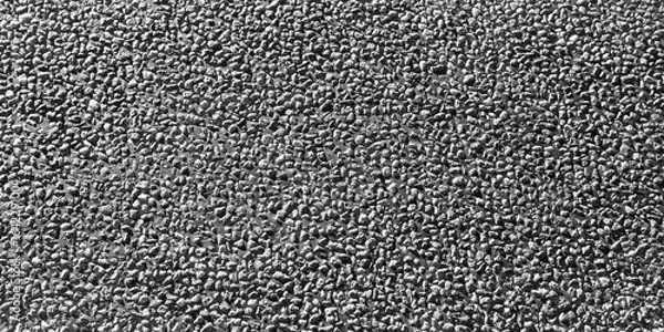 Fototapeta Textured surface of black asphalt with a rough, gritty appearance, showcasing the intricate details and patterns of the material, ideal for backgrounds and design projects. Banner with copy space