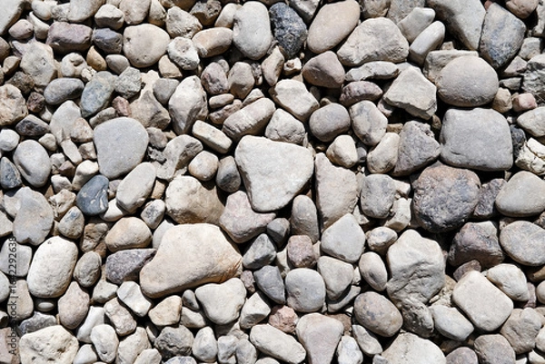 Fototapeta Abstract background with brown and beige dry stones, cobblestones, gravel. Gravel texture or background closeup for design, for banner. Real grunge background texture and small stone.