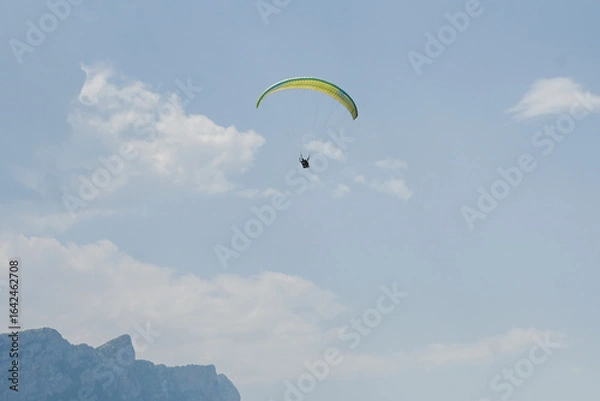 Fototapeta Man paragliding in the town of Organya in the province of Lleida in northern Spain in August 2025.