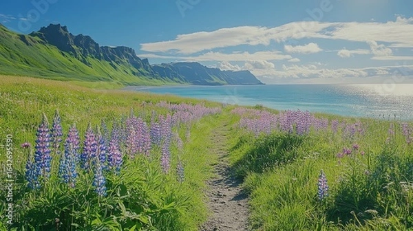 Fototapeta A scenic path lined with vibrant purple flowers leads to a tranquil sea, framed by majestic cliffs and a clear blue sky.