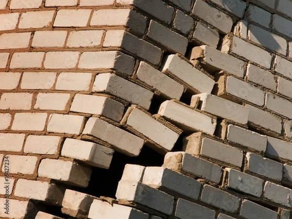 Fototapeta Destruction a wall of the house from a brick