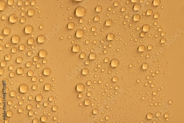 Obraz the surface is orange , covered with water droplets , and there is a beautiful wet yellow film with a large number of water droplets