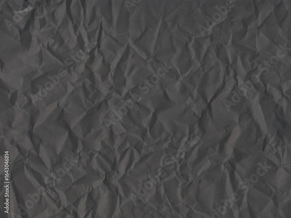 Fototapeta Black crumpled paper texture background with rough folds. Perfect for grunge design, packaging, vintage style