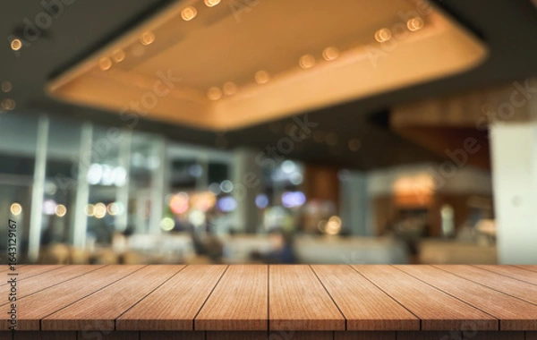 Fototapeta Empty wooden table top with lights bokeh on blur restaurant background.