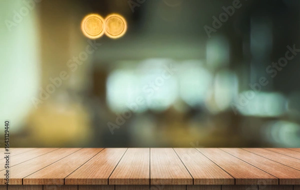 Fototapeta Empty wooden table top with lights bokeh on blur restaurant background.