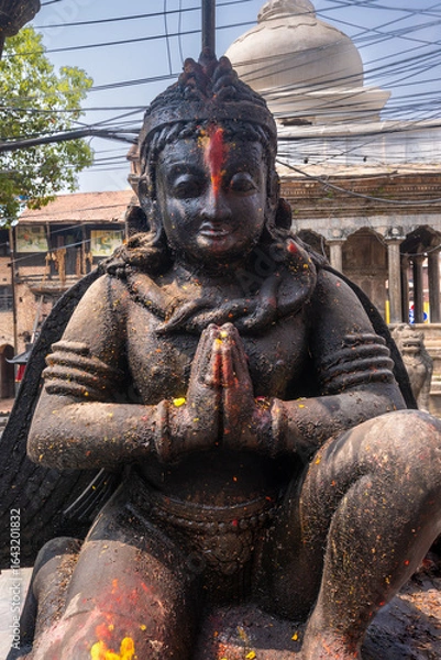 Fototapeta Close-up view of a Tibetan Buddhist man deity as a stone statue, symbolizing protection and the destruction of evil spirits.