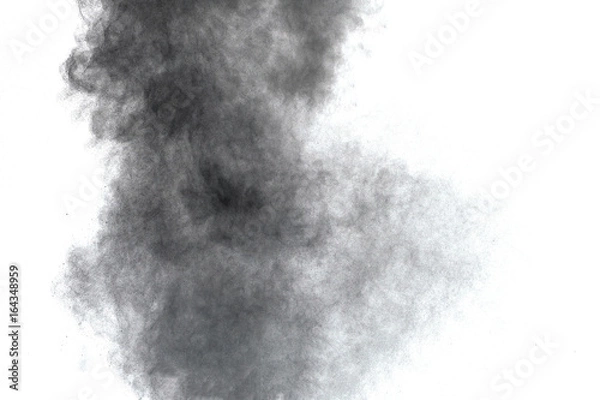 Fototapeta Black powder explosion. Closeup of black dust particles explode isolated on white background.