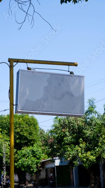 Obraz blank billboard on the street with blue sky background