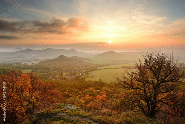 Fototapeta Wonderful beautiful amazing autumn fall sunrise in landscape of Czech Central Mountains, colorful clouds, fields and trees, serenity and peace