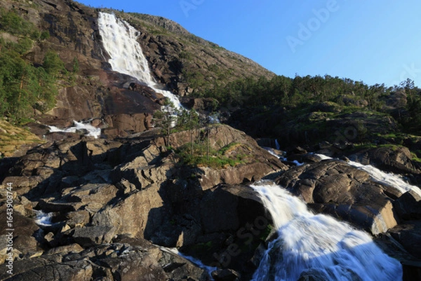 Fototapeta Landscape photo with a side view of the cliffs and Langfossen waterfall in the evening in southern Norway	