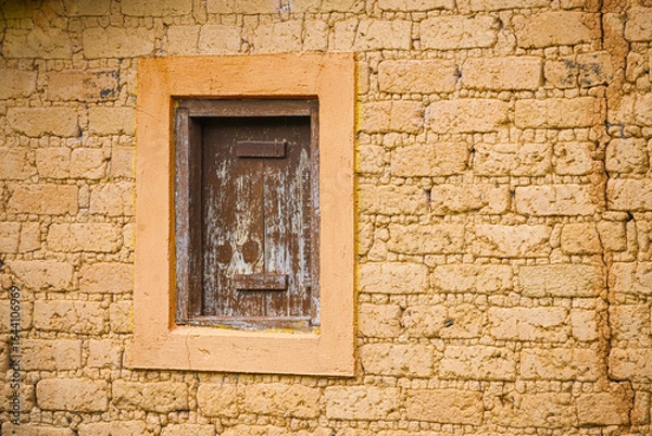 Fototapeta adobe brick wall with rustic window