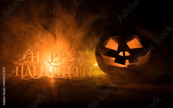 Fototapeta Halloween concept. Creepy silhouette in the dark corridor with pumpkin head. Toned light with fog on background.