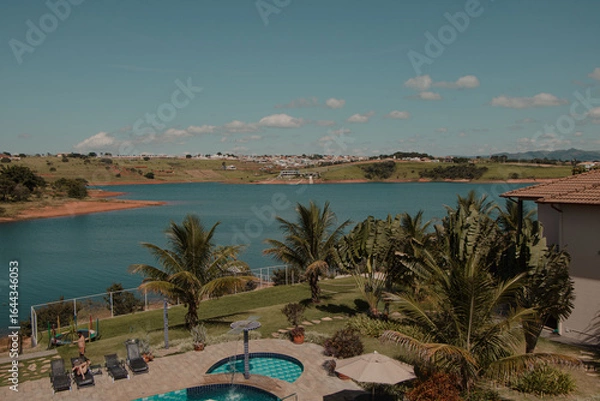Fototapeta Scenic Lake View with Resort and Palm Trees