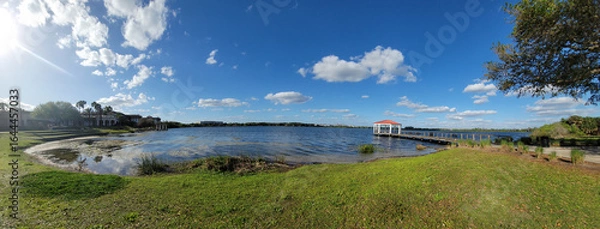 Fototapeta Lake Baldwin Park in Orlando, Winter Park, Florida, USA. Lake view landscape with red gazebo. Ecological Park for visitors on a travel vacation in Orlando, Florida, USA.