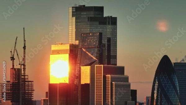 Obraz Modern glass skyscrapers in London financial district at golden hour. Sunset light reflecting on glass facades of buildings. Cityscape skyline background. Panorama shot