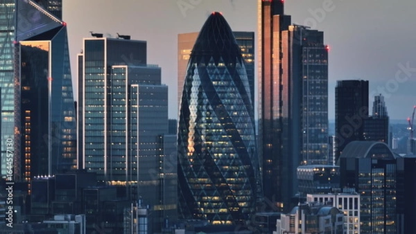 Obraz United Kingdom, London: Aerial view capturing the London skyline at sunset, highlighting modern skyscrapers and the iconic Gherkin amidst the cityscape. Drone flight