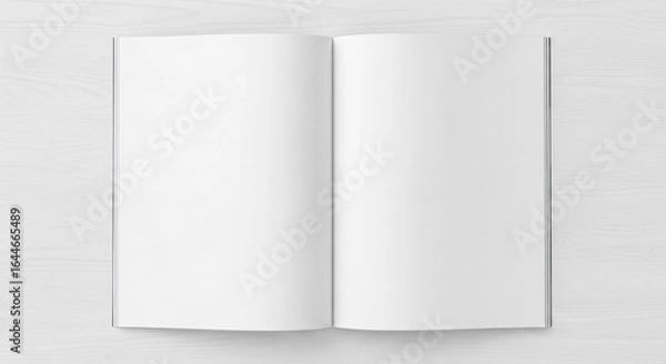 Fototapeta Blank magazine pages open on a bright, clean wooden surface