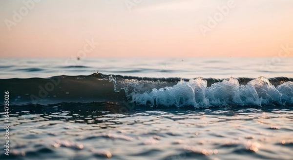 Fototapeta Gentle Ocean Wave at Sunset with Sparkling Water