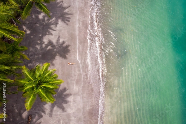 Fototapeta Girl lying on a beach from above in Panama