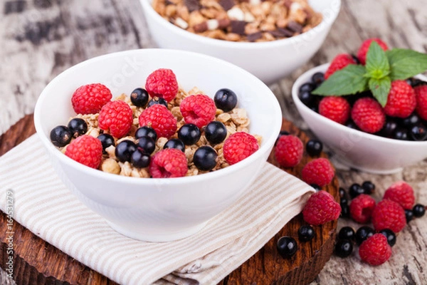Fototapeta muesli breakfast on a wooden table