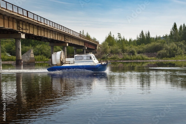 Obraz Hovercraft passes under the bridge