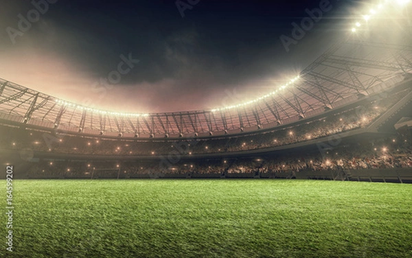 Obraz soccer stadium at night with illumination lights and dramatic sky