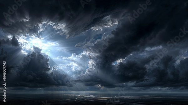 Obraz Dramatic cloud formations with sunlight breaking through over a calm ocean during twilight