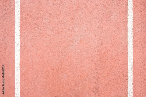 Fototapeta surface of the red running track in the stadium on top view for copy space emtry background.