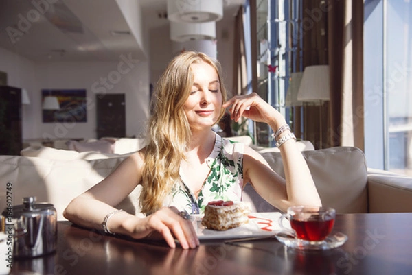 Obraz Pretty Young Woman Sitting in the Cafe with a Cup of Tea. Looking in the Window