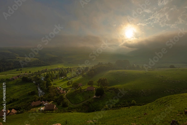 Obraz Diffused sunlight through low clouds at sunset