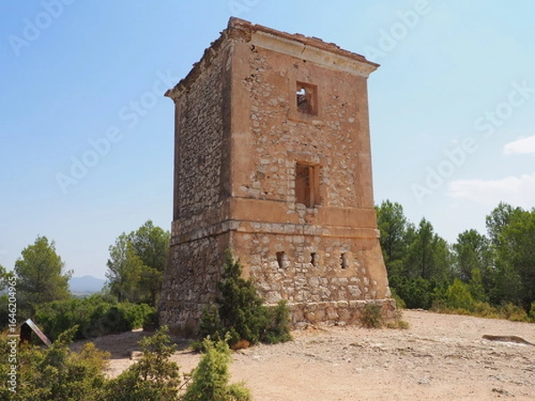Obraz Requena,19th century telegraph tower in Mediterranean countryside, historic communication building under bright blue sky 