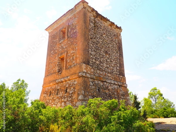 Obraz Requena,19th century telegraph tower in Mediterranean countryside, historic communication building under bright blue sky 