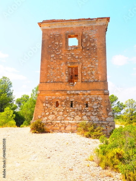 Obraz Requena,19th century telegraph tower in Mediterranean countryside, historic communication building under bright blue sky 