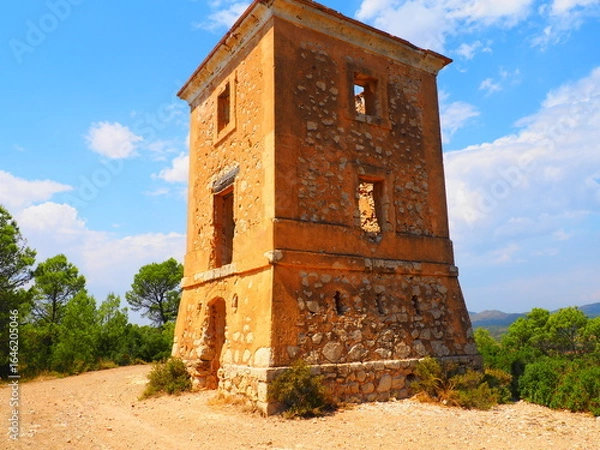 Obraz Requena,19th century telegraph tower in Mediterranean countryside, historic communication building under bright blue sky 