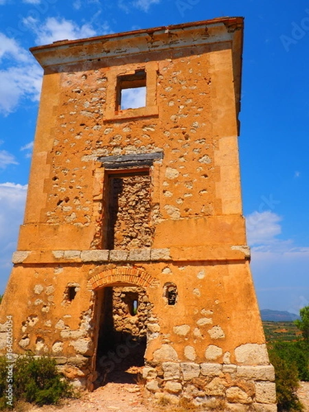 Obraz Requena,19th century telegraph tower in Mediterranean countryside, historic communication building under bright blue sky 