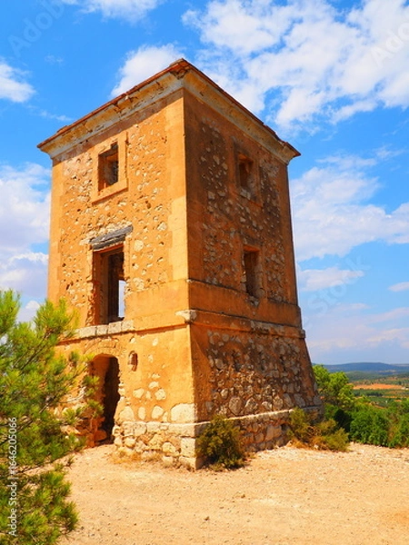 Obraz Requena,19th century telegraph tower in Mediterranean countryside, historic communication building under bright blue sky 