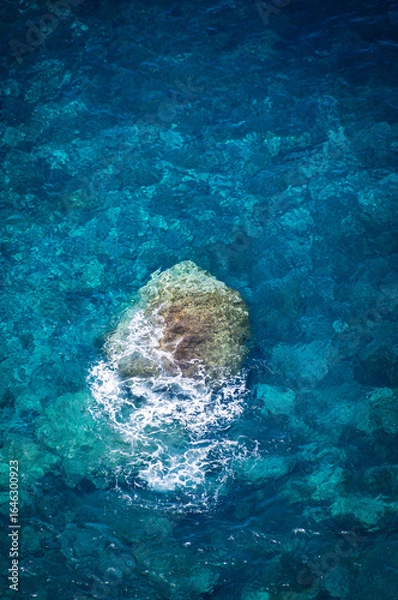 Fototapeta Lonely Rock Breaking a Wave in Atlantic Waters