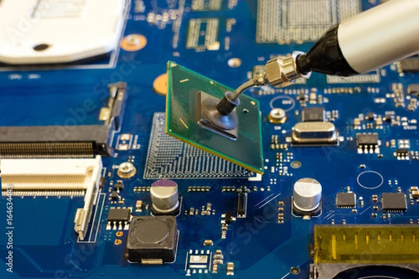 Obraz Removal of the chip by vacuum tweezers. Work on the disassembling of electronic components