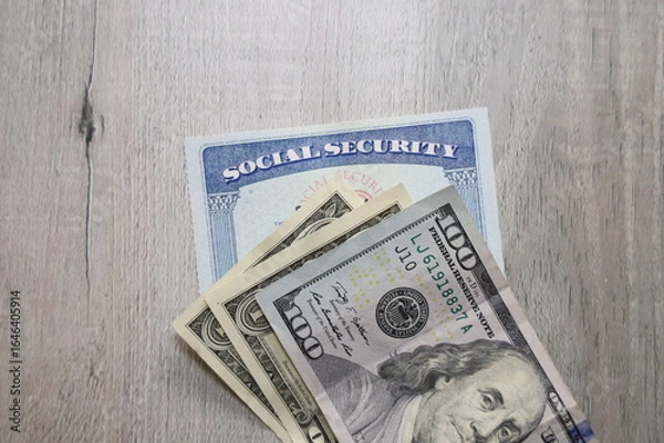 Obraz Social security card a US bills. Income at retirement concept.