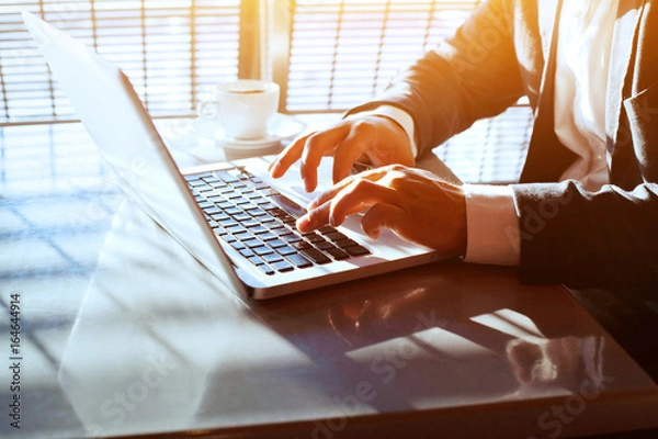 Obraz business travel, working on computer laptop online, closeup of hands of businessman, person using wifi internet in the airport