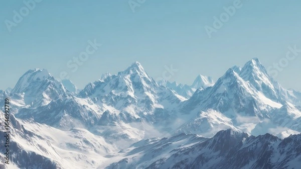 Fototapeta Snow-capped mountain range under a clear sky.