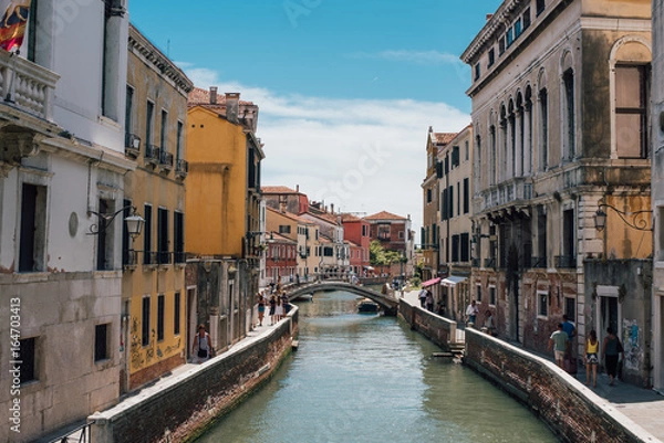 Obraz View on a venetian canal with ancient buildings and bridge in Venice