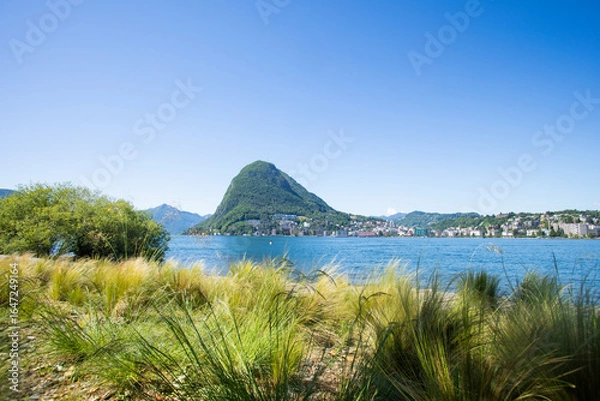 Fototapeta View of Lugano's lake and Mount San Salvatore in Svittera. Fantastic weather with sunny summer and spring day and blue sky.  Silence