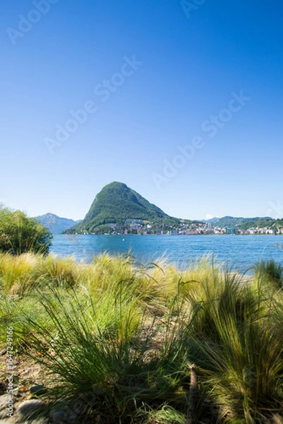 Fototapeta View of Lugano's lake and Mount San Salvatore in Svittera. Fantastic weather with sunny summer and spring day and blue sky.  Silence