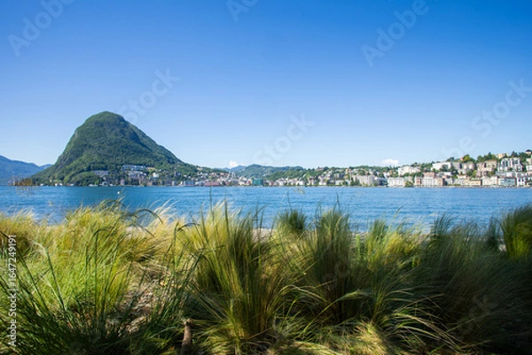 Fototapeta View of Lugano's lake and Mount San Salvatore in Svittera. Fantastic weather with sunny summer and spring day and blue sky.  Silence