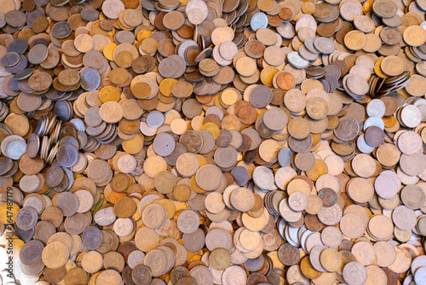 Fototapeta Pile of coins with a variety of colors