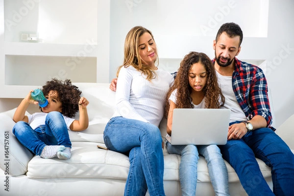 Obraz Young family sitting on the couch